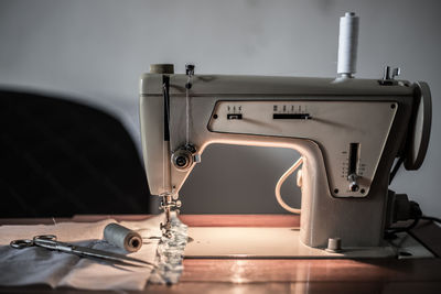 Close-up of sewing machine on table