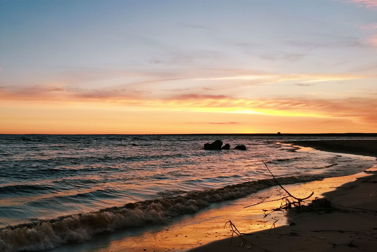 sunset, sea, horizon over water, water, beach, scenics, sky, orange color, tranquil scene, beauty in nature, tranquility, shore, idyllic, nature, cloud - sky, cloud, outdoors, remote, coastline, no people, non-urban scene, dramatic sky, sun, rippled, ocean, tourism, majestic