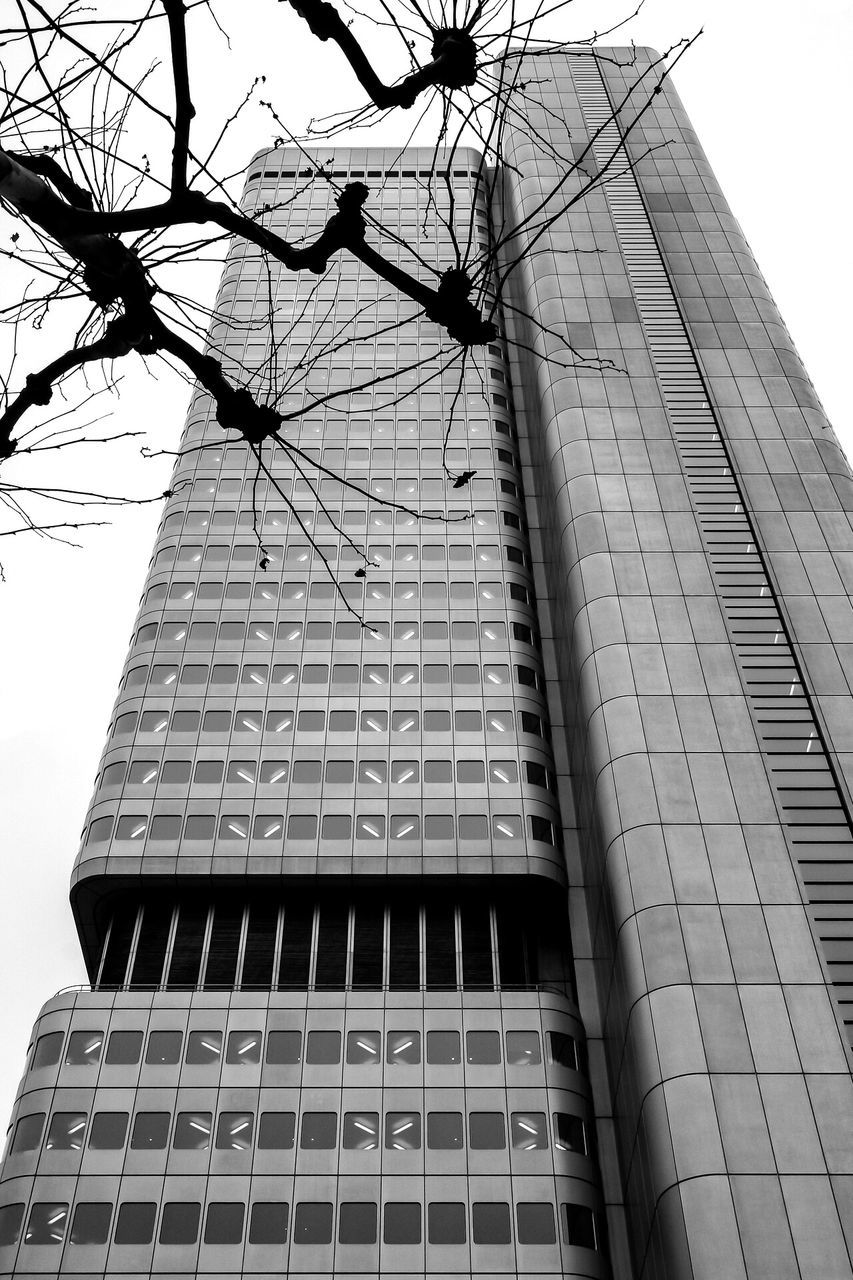 low angle view, building exterior, architecture, built structure, tall - high, tower, city, clear sky, sky, power line, building, office building, cable, tall, skyscraper, day, modern, outdoors, no people, street light