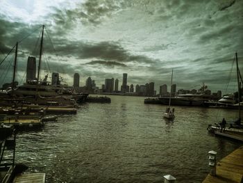 View of harbor against cloudy sky