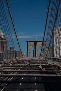 View of suspension bridge against blue sky