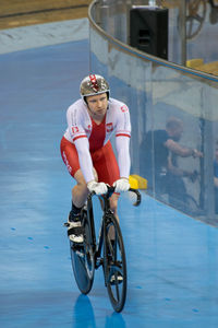 Full length of young man riding bicycle