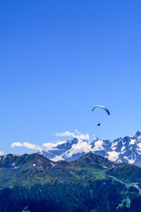 Scenic view of mountains against blue sky