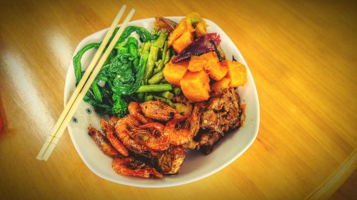 High angle view of food in plate on wooden table