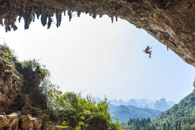 Man climbing at odin's den in yangshuo, a climbing mekka in china