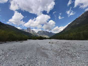 Scenic view of mountains against cloudy sky