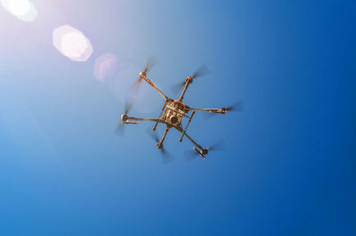 Agricultural drone in flight on a background of blue sky. field spraying new technologies.