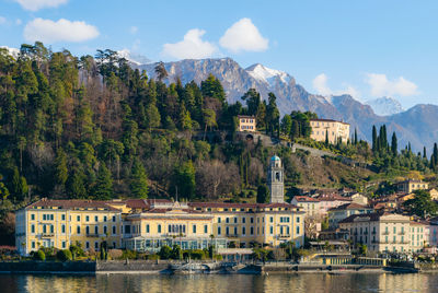 Scenic view of river with houses in background