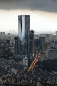 High angle view of buildings in city at dusk