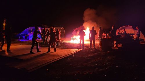 Group of people by fire at night