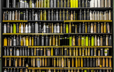 Full frame shot of bottles arranged in shelves