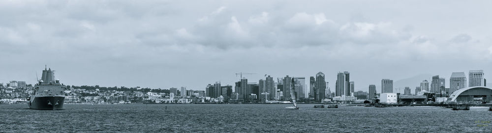 Panoramic view of sea and buildings against sky