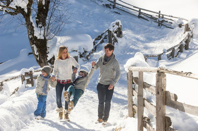 Happy family walking in snow