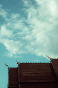 Low angle view of roof and building against sky