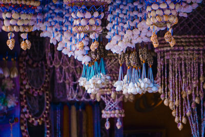 Close-up of souvenirs hanging for sale in market stall