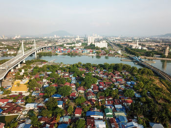 High angle view of bridge over river and buildings in city