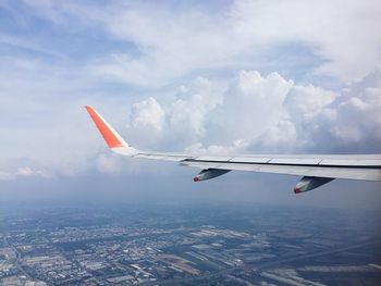 Airplane looking out from window while flying on the sky looking down to earth 