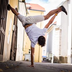 Young man exercising in city