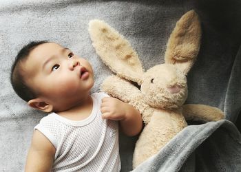 Close-up of cute baby with easter bunny at home