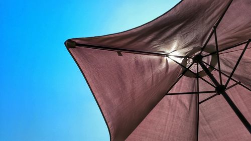 Low angle view of beach umbrella against clear sky