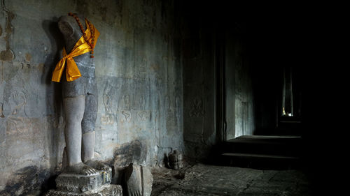 Rear view of woman walking in tunnel