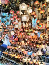 Close-up of illuminated lanterns hanging in store