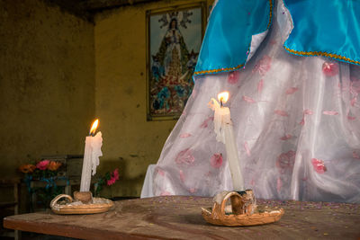 Panoramic view of candles on table in illuminated building