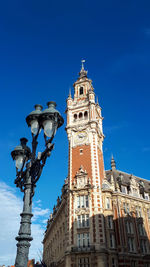 Low angle view of clock tower against sky