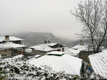 Scenic view of frozen mountains against sky during winter