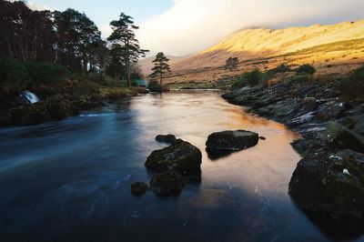 Beautiful sunrise landscape scenery mountains reflected in river erriff at aesleagh in mayo, ireland