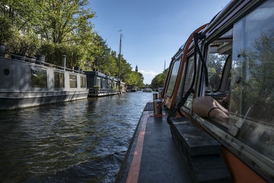 Train on bridge over river against sky
