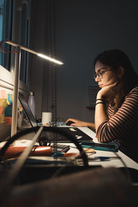 Young woman using mobile phone at home