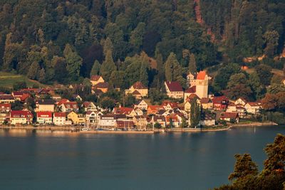 Scenic view of lake by buildings in city