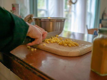 Person preparing food on table at home