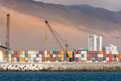 Commercial dock by sea against sky