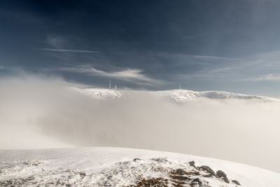 Scenic view of snow covered mountains against sky