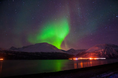 Scenic view of lake against sky at night