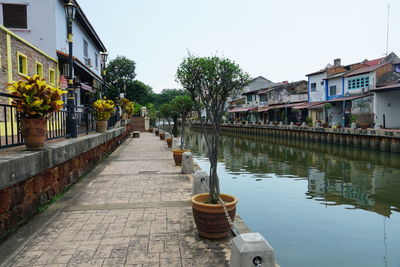 Canal amidst buildings against sky