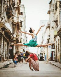 Woman jumping on street