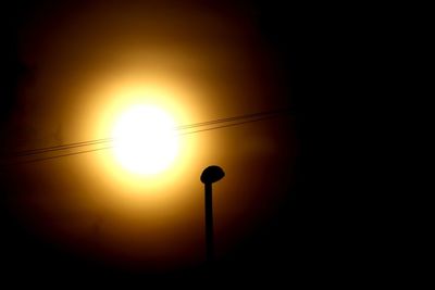 Silhouette street light against sky during sunset