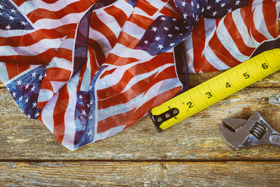 Directly above shot of tape measure with pen and wrench on table