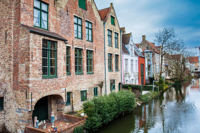 Canal amidst buildings against sky