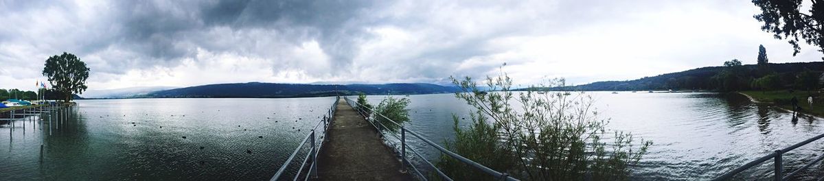 Scenic view of lake against cloudy sky