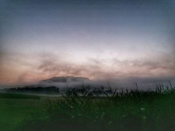 Scenic view of field against sky during sunset