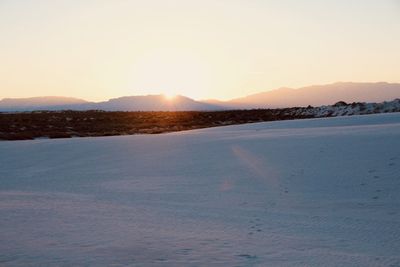 Scenic view of landscape against clear sky during sunset