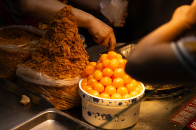 Cropped hand of person preparing food