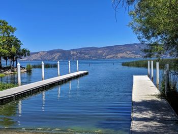 Scenic view of lake and docks against clear blue sky. diagonal. 