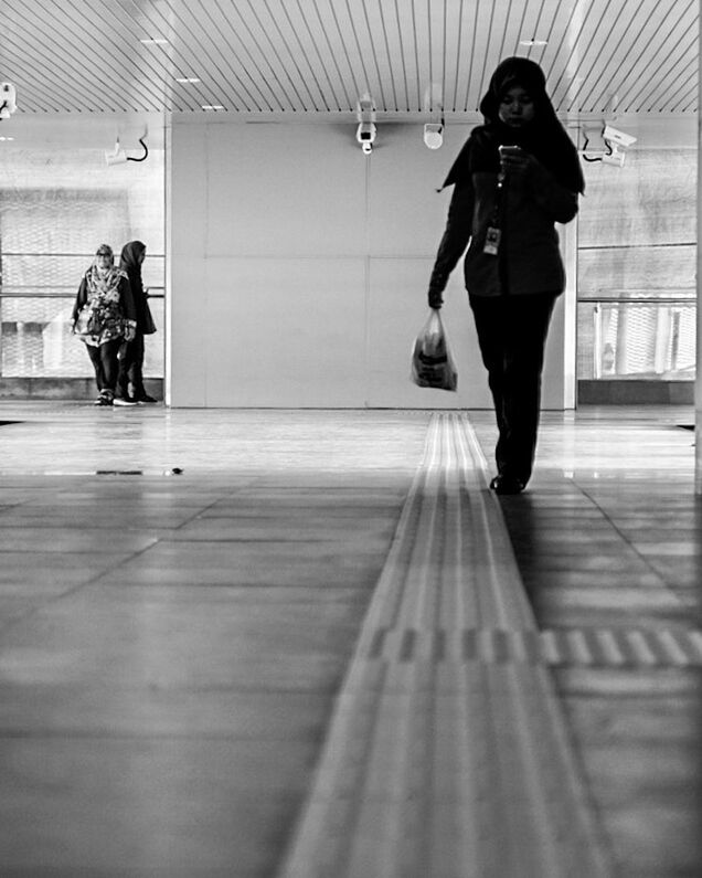 FULL LENGTH REAR VIEW OF WOMEN WALKING IN CORRIDOR