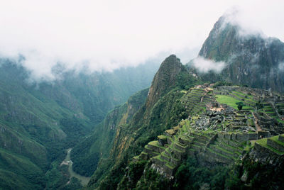 Scenic view of landscape against sky during rainy season