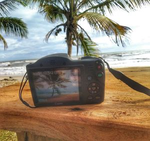 Close-up of camera on beach